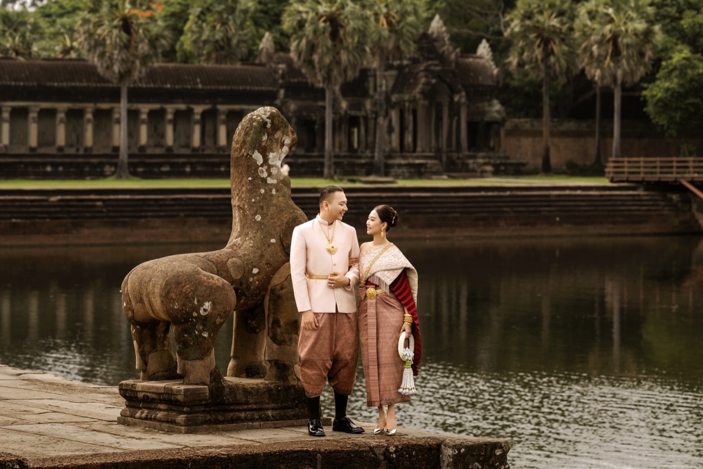 By the lion statue at the temple moat